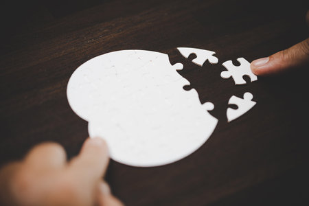 Business woman person hand with puzzle piece idea for strategy and solution. Closeup part of two white jigsaw connect together. Concept of join cooperation success teamwork-problem corporate team.の写真素材