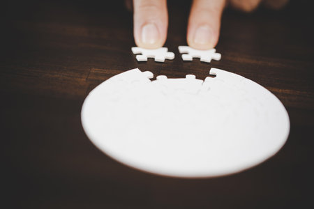 Business woman person hand with puzzle piece idea for strategy and solution. Closeup part of two white jigsaw connect together. Concept of join cooperation success teamwork-problem corporate team.の写真素材