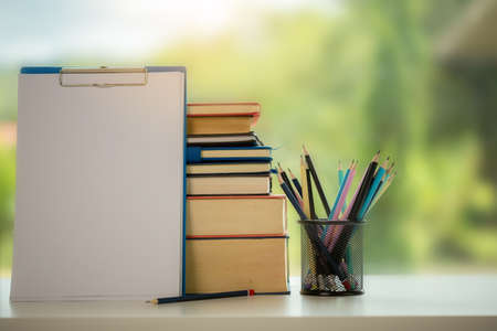 Object education green nature background with stack of ancient books or old bible, open paper book on wooden table with copy space. concept of back to school, research studyの写真素材