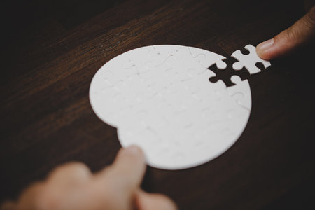 Business woman person hand with puzzle piece idea for strategy and solution. Closeup part of two white jigsaw connect together. Concept of join cooperation success teamwork-problem corporate team.の写真素材