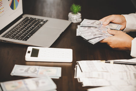 Cash money for home budget expenses. Calculation ideas for house loan, Savings for real estate, finance business payment investment for mortgage property, Agents-brokers calculate insurance on hand.の写真素材