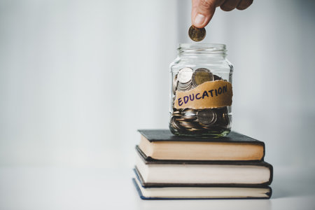 close-up education object with stack money coin-cash dollar and glass jar on background. Concept to saving money income for study, Calculating student finance costs and investment budget loanの写真素材