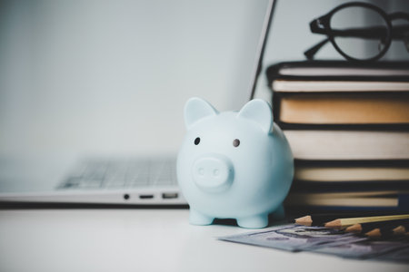 close-up education object with stack money coin-cash dollar and glass jar on background. Concept to saving money income for study, Calculating student finance costs and investment budget loanの写真素材