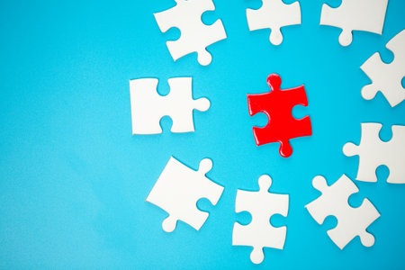 White part of jigsaw puzzle pieces on blue background. concepts of problem solving, business success, teamwork, Team playing jigsaw game incomplete, Texture photo with copy space for textの写真素材