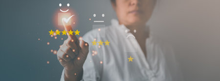 Customer service and Satisfaction concept, Business person are touching the virtual screen on happy Smiley face icon to give satisfaction in service. rating very impressed. customer service feedback.の写真素材