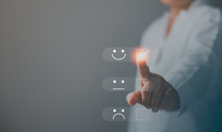 Customer service and Satisfaction concept, Business person are touching the virtual screen on happy Smiley face icon to give satisfaction in service. rating very impressed. customer service feedback.の写真素材