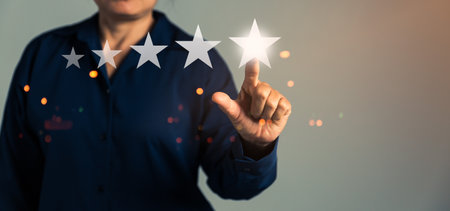 Customer service feedback. Business person are touching the virtual screen on happy Smiley face icon to give satisfaction in service. Customer service and Satisfaction concept, rating very impressed.の写真素材