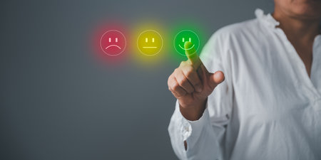 Business person are touching the virtual screen on happy Smiley face icon to give satisfaction in service. Customer service and Satisfaction concept, rating very impressed. customer service feedback.の写真素材