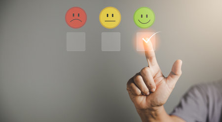 Customer service and Satisfaction concept, Business person are touching the virtual screen on happy Smiley face icon to give satisfaction in service. rating very impressed. customer service feedback.の写真素材
