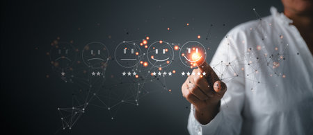 Business person are touching the virtual screen on happy Smiley face icon to give satisfaction in service. Customer service and Satisfaction concept, rating very impressed. customer service feedback.の写真素材