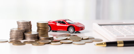 Car toy vehicle with stack coin money on background. Planning to manage transportation finance costs. Concept of car insurance business, saving buy - sale with tax and loan for new car.の写真素材
