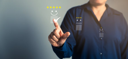 Customer service and Satisfaction concept, Business person are touching the virtual screen on happy Smiley face icon to give satisfaction in service. rating very impressed. customer service feedback.の写真素材
