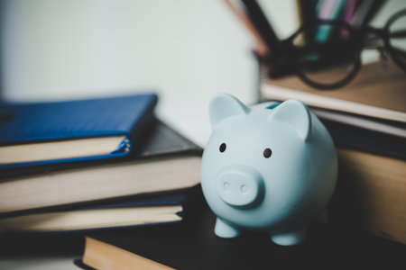 close-up education object with stack money coin-cash dollar and glass jar on background. Concept to saving money income for study, Calculating student finance costs and investment budget loanの写真素材