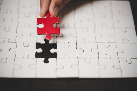 Business woman person hand with puzzle piece idea for strategy and solution. Closeup part of two white jigsaw connect together. Concept of join cooperation success teamwork-problem corporate team.の写真素材