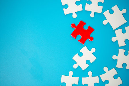 White part of jigsaw puzzle pieces on blue background. concepts of problem solving, business success, teamwork, Team playing jigsaw game incomplete, Texture photo with copy space for textの写真素材