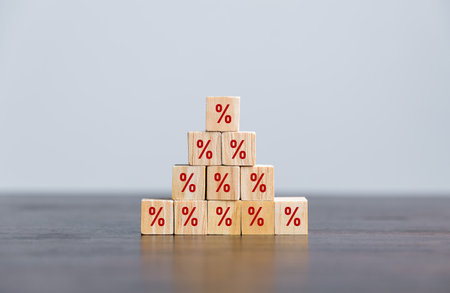 Closeup wood cubes with percentage symbol, business interest, discount investment, financial growth, interest rate increase, sale price and tax rise, future gain, market digital conceptの写真素材