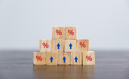 Closeup wood cubes with percentage symbol, Percent and upwards increasing arrows on wooden cubes. Financial interest mortgage rates increase or price commission raise, growth business, finance tax.の写真素材