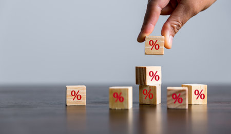 Closeup wood cubes with percentage symbol, Interest rate and dividend concept, wooden block with percentage symbol and up arrow, return on stocks and mutual funds, long term investment for retirement.の写真素材