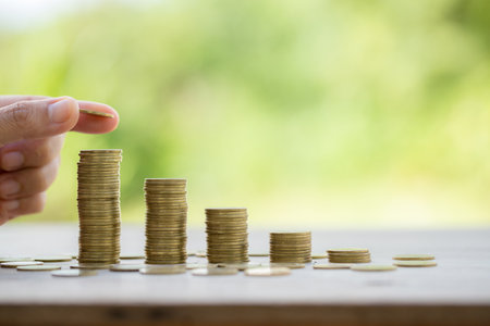 Female hand holding or putting money coin for saving. management cash, insurance asset and wealth, tax accounting budget, growth loan financial, economic, savings for business investments concept.の写真素材