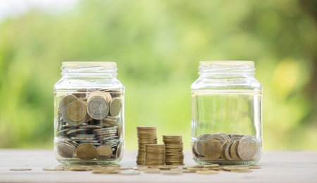 Savings for business investments concept. Money coin stacking on wood desk in green background. management cash, insurance asset and wealth, tax accounting budget, growth loan financial, economic.の写真素材