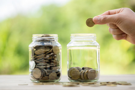 Female hand holding or putting money coin for saving. management cash, insurance asset and wealth, tax accounting budget, growth loan financial, economic, savings for business investments concept.の写真素材