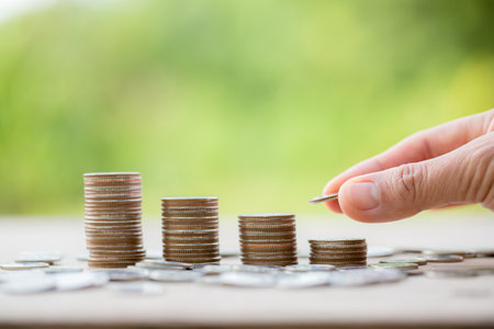 Female hand holding or putting money coin for saving. management cash, insurance asset and wealth, tax accounting budget, growth loan financial, economic, savings for business investments concept.の写真素材