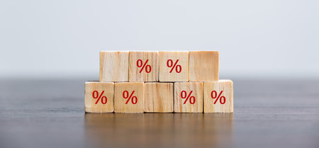 Closeup wood cubes with percentage symbol, business interest, discount investment, financial growth, interest rate increase, sale price and tax rise, future gain, market digital conceptの写真素材