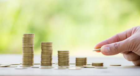 Female hand holding or putting money coin for saving. management cash, insurance asset and wealth, tax accounting budget, growth loan financial, economic, savings for business investments concept.の写真素材