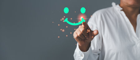 Customer service and Satisfaction concept, Excellent consumer feedback. Business people are touching virtual screen on happy Smiley face icon to give satisfaction in service. rating very impressed.の写真素材