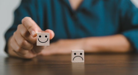 Satisfaction survey concept. Customer services best excellent business rating experience. Hand of business chooses a smile face on wood block circle. 5 Star Satisfaction. People feel great product.の写真素材
