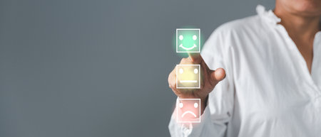 Customer service and Satisfaction concept, Excellent consumer feedback. Business people are touching virtual screen on happy Smiley face icon to give satisfaction in service. rating very impressed.の写真素材