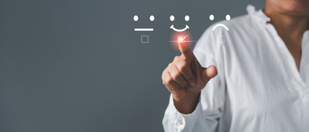 Customer service and Satisfaction concept, Excellent consumer feedback. Business people are touching virtual screen on happy Smiley face icon to give satisfaction in service. rating very impressed.の写真素材