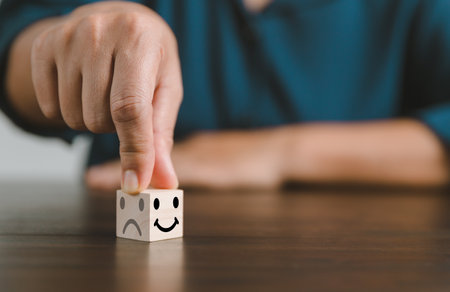 Satisfaction survey concept. Customer services best excellent business rating experience. Hand of business chooses a smile face on wood block circle. 5 Star Satisfaction. People feel great product.の写真素材