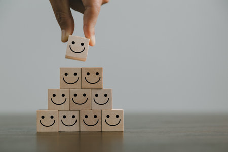 Satisfaction survey concept. Customer services best excellent business rating experience. Hand of business chooses a smile face on wood block circle. 5 Star Satisfaction. People feel great product.の写真素材