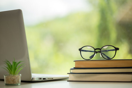 Object education green nature background with stack of ancient books or old bible, open paper book on wooden table with copy space. concept of back to school, research studyの写真素材