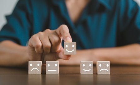Satisfaction survey concept. Customer services best excellent business rating experience. Hand of business chooses a smile face on wood block circle. 5 Star Satisfaction. People feel great product.の写真素材