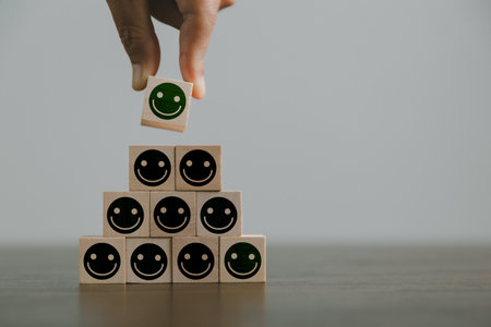 Satisfaction survey concept. Customer services best excellent business rating experience. Hand of business chooses a smile face on wood block circle. 5 Star Satisfaction. People feel great product.の写真素材
