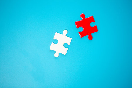 White part of jigsaw puzzle pieces on blue background. concepts of problem solving, business success, teamwork, Team playing jigsaw game incomplete, Texture photo with copy space for textの写真素材