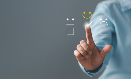 Customer service and Satisfaction concept, Excellent consumer feedback. Business people are touching virtual screen on happy Smiley face icon to give satisfaction in service. rating very impressed.の写真素材