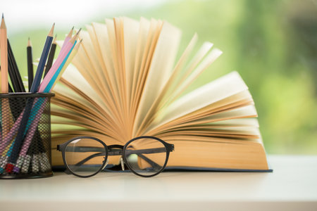 Object education green nature background with stack of ancient books or old bible, open paper book on wooden table with copy space. concept of back to school, research studyの写真素材
