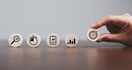 Target or goal with strategy plan-success business revenue concept. Symbols of arrows-diagrams businesses are present on wood cube. objective management, achievement startup, growth marketing idea.の写真素材