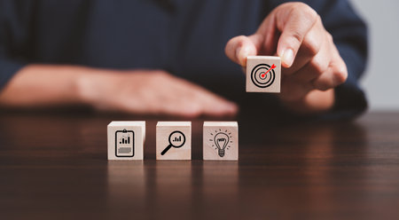 Target or goal with strategy plan-success business revenue concept. Symbols of arrows-diagrams businesses are present on wood cube. objective management, achievement startup, growth marketing idea.の写真素材