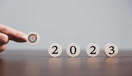 Target or goal with strategy plan-success business revenue concept. Symbols of arrows-diagrams businesses are present on wood cube. objective management, achievement startup, growth marketing idea.の写真素材