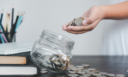 Saving money coin with banking investment, finance education concept. Planning student loan for studying abroad for college or university degree. Future children's education fund cash. Growing savingの写真素材