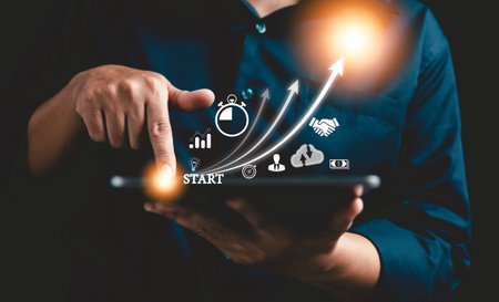 Startup concept with icon business and network connection on modern virtual interface from digital tablet. People hand touching on tablet. Developing and improving organization with modern technology.の写真素材