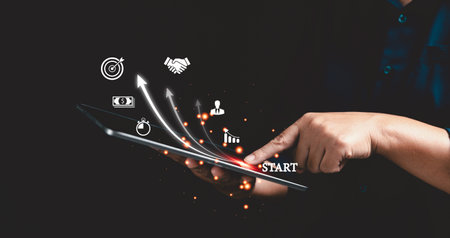 Startup concept with icon business and network connection on modern virtual interface from digital tablet. People hand touching on tablet. Developing and improving organization with modern technology.の写真素材