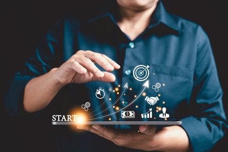 Startup concept with icon business and network connection on modern virtual interface from digital tablet. People hand touching on tablet. Developing and improving organization with modern technology.の写真素材