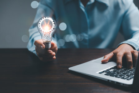 woman Hand holding Light bulb Global Internet connection. Business global internet connection application technology and digital marketing, Financial and banking, Digital link tech, big data.の写真素材