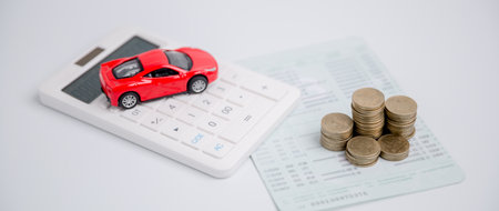 Concept of car insurance business, saving buy - sale with tax and loan for new car. Car toy vehicle with stack coin money on background. Planning to manage transportation finance costs. loan for carの写真素材