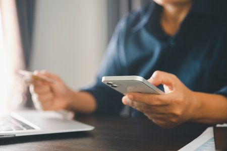 Woman hands of using online virtual app on mobile phone. Millennial guy chatting on smartphone, using banking services, reading text message, typing, shopping, making call, browsing internet.Close upの写真素材